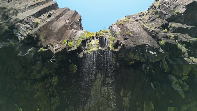 Low angle footage of the Satvorenieto Waterfall on a sunny day in Dolna kula village, Bulgaria