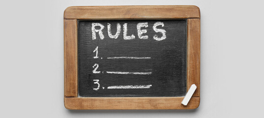 Chalkboard with blank list of rules on light background