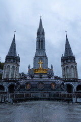 Basilica of the Immaculate Conception in Lourdes, France with Golden Crown Dome and Spires