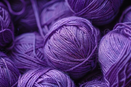 Close up of vibrant purple yarn balls, creating a textured backdrop ideal for knitting, crochet, and craft projects