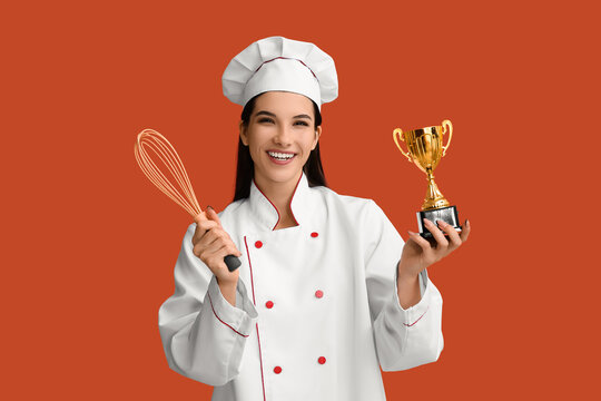 Female chef with gold cup and whisk on orange background