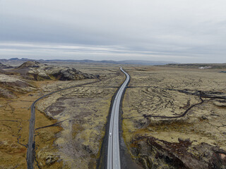 Aerial view of a highway cutting through the volcanic landscape of Hellisheidi, south Iceland...