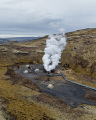 Aerial view of a geothermal power plant emitting steam on Hellisheidi, south Iceland.