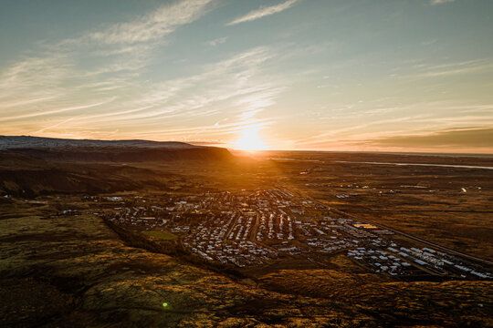 Aerial view of Hveragerdi at sunrise, surrounded by Iceland&rsquo;s golden landscapes...