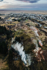 Aerial view of Hveragerdi, South Iceland, with steaming geothermal vents and scenic townscape