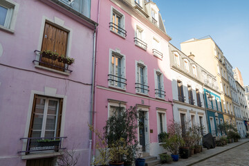 Charming pink buildings line a quiet street in a historic neighborhood