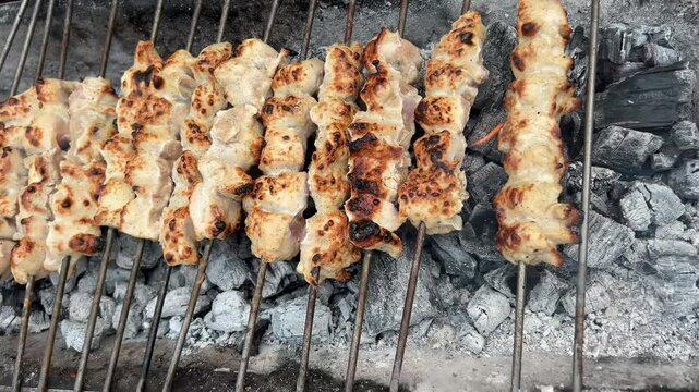 Chicken reshmi kabab burnt in charcoal in skewers in India.