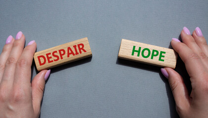 Despair or Hope symbol. Concept word Despair or Hope on wooden blocks. Businessman hand. Beautiful...
