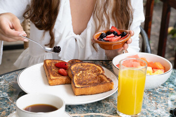 Desayuno: tostada francesa con frutos rojos, jugo y cafe