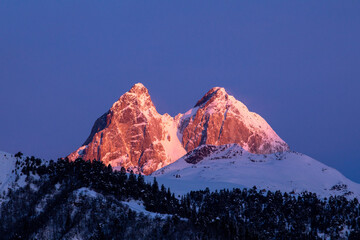 Snow-capped mountains at sunset with deep blue sky in Georgia