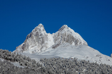 Majestic Snow-Covered Mountain Peaks Under Clear Blue Sky in Georgia