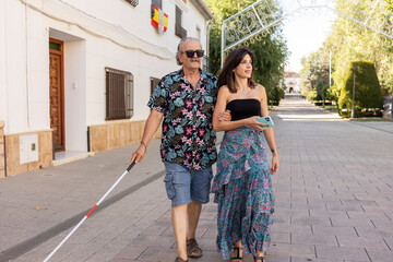 Blind father guided by daughter in urban setting