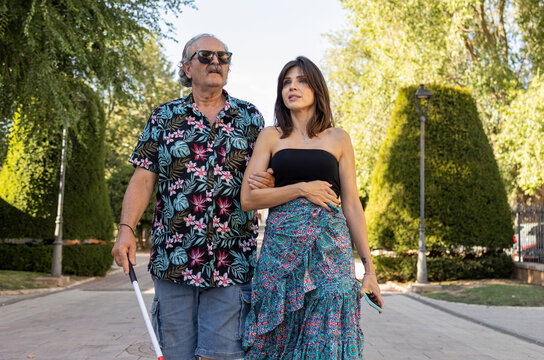 Blind father guided by daughter in scenic town walk