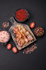 Delicious bacon in the form of slices with salt, spices and herbs