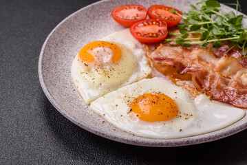 A hearty breakfast with fried eggs, bacon, tomatoes, microgreens