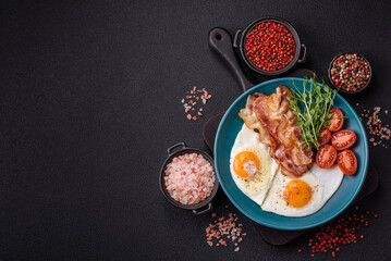 A hearty breakfast with fried eggs, bacon, tomatoes, microgreens