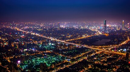 Fototapeta premium Night city aerial view, illuminated streets, park, skyscrapers