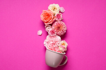 Composition with cup and beautiful flowers on pink background