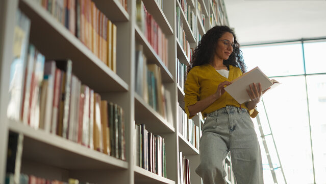 Hispanic Latina woman student library choosing books textbooks bookstore learning education female exam preparation girl read bookworm smart teacher reader archive lesson study high school university
