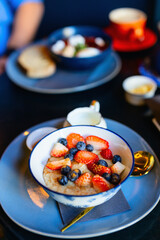 Oatmeal topped with fresh strawberries and blueberries
