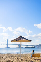 Tourist sitting on Busan beach.