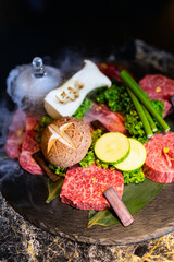 Premium Hanwoo Korean beef slices with garnish display