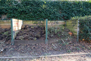 Compost bins filled with organic waste in a community garden area