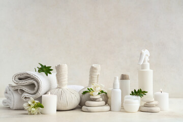 Composition with different cosmetic products, spa accessories, burning candles and flowers on light background