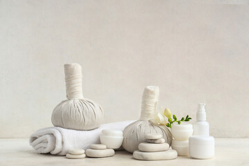 Different cosmetic products, spa accessories and freesia flower on light background