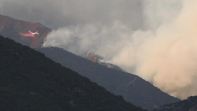 4k video of the California wild fires airplane throwing water and phos check on the fires