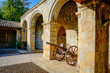 Antique bronze cannon with large wooden wheels