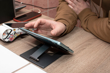 A man working on a tablet computer in cafe	