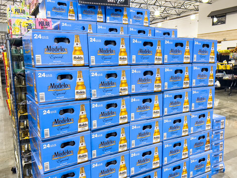 Cartons of Modelo Brand Mexican Beer bottles for sale in a supermarket aisle	