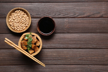 Bowl with pieces of fried tofu cheese and micro green on wooden background