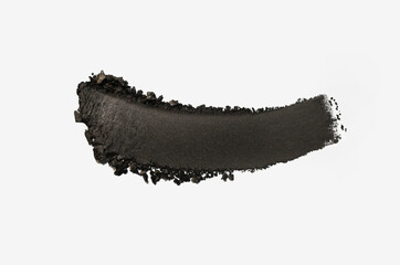 Eye shadow matte charcoal black colored brush stroke on grey isolated background