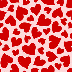 Seamless pattern with red hearts on a light pink background. Vector Valentine's day  background.