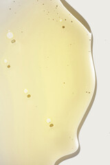 Cream gel yellow transparent cosmetic sample texture with bubbles on grey isolated background