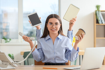 Young secretary with a lot of work at table in office
