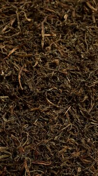 Dried Jimbu (Jimmu, Jamboo, Faran) background texture. It is a herb belonging to the onion family, used extensively in Nepal and in some Himalayan states of India. Table spin. Vertical video.