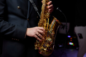 Naklejka premium An Elegant and Talented Saxophonist Skillfully Playing a Stunning Golden Saxophone