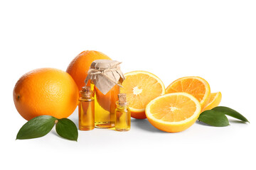 Bottles of orange essential oil and fresh fruits on white background