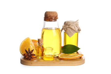 Bottles of orange essential oil and star anise on white background