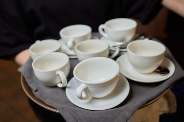 Elegant White Teacups Arranged on a Tray Perfect for a Stylish and Chic Gathering Event