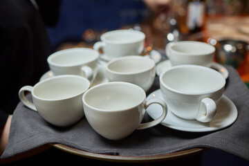 Elegant White Teacups Arranged on a Tray Perfect for a Stylish and Chic Gathering Event