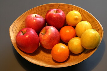Fruit basket with apples, oranges and lemons. 