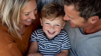 Obraz premium Happy Family Portrait on Cozy Sofa with Natural Sunlight