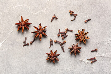 Anise stars and cloves on grey background