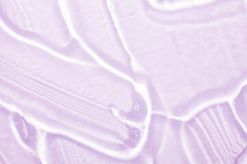 Beauty skin care product. Liquid water gel smudge cosmetic purple textured background