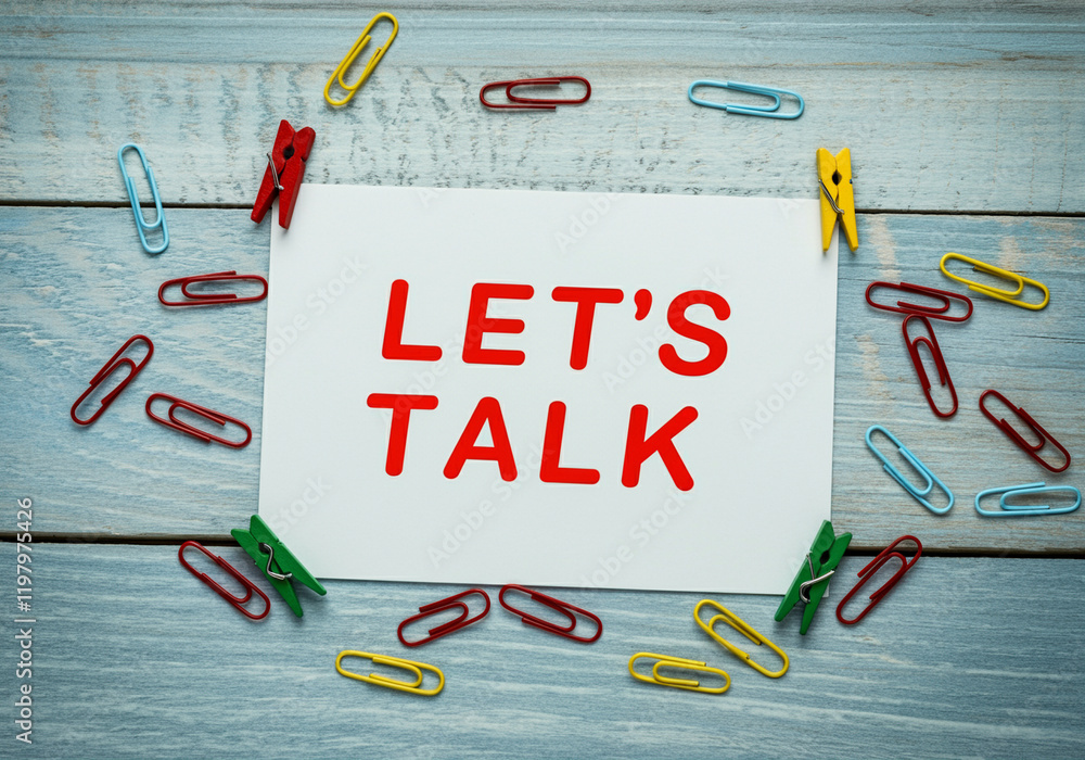 Poster text message let's talk on paper with colorful paperclips in business setting