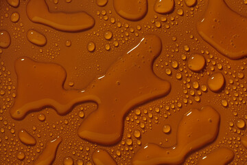 Cosmetic beauty product. Brown orange texture, transparent liquid
